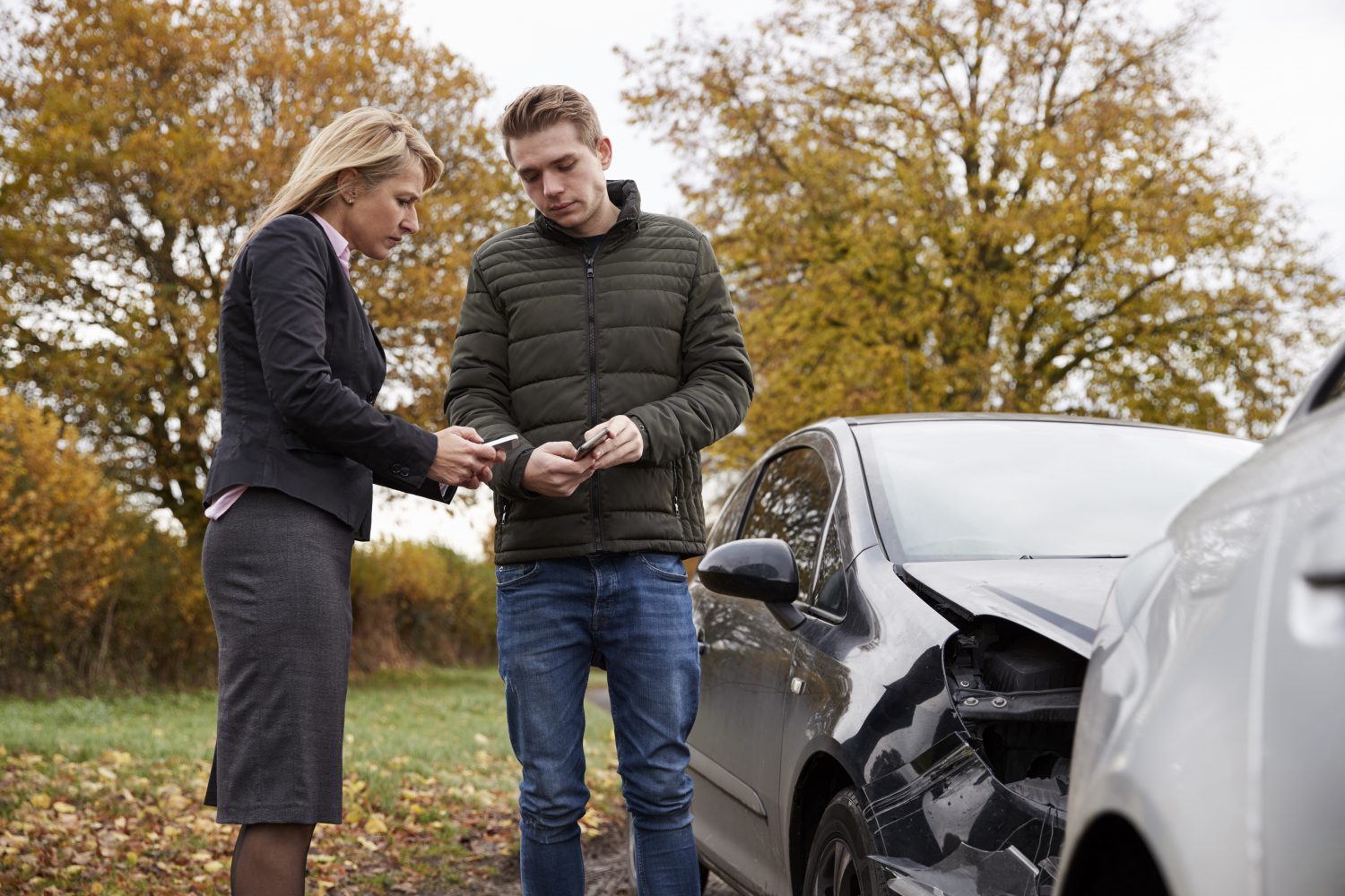Two Drivers Exchanging Insurance Details After Car Accident